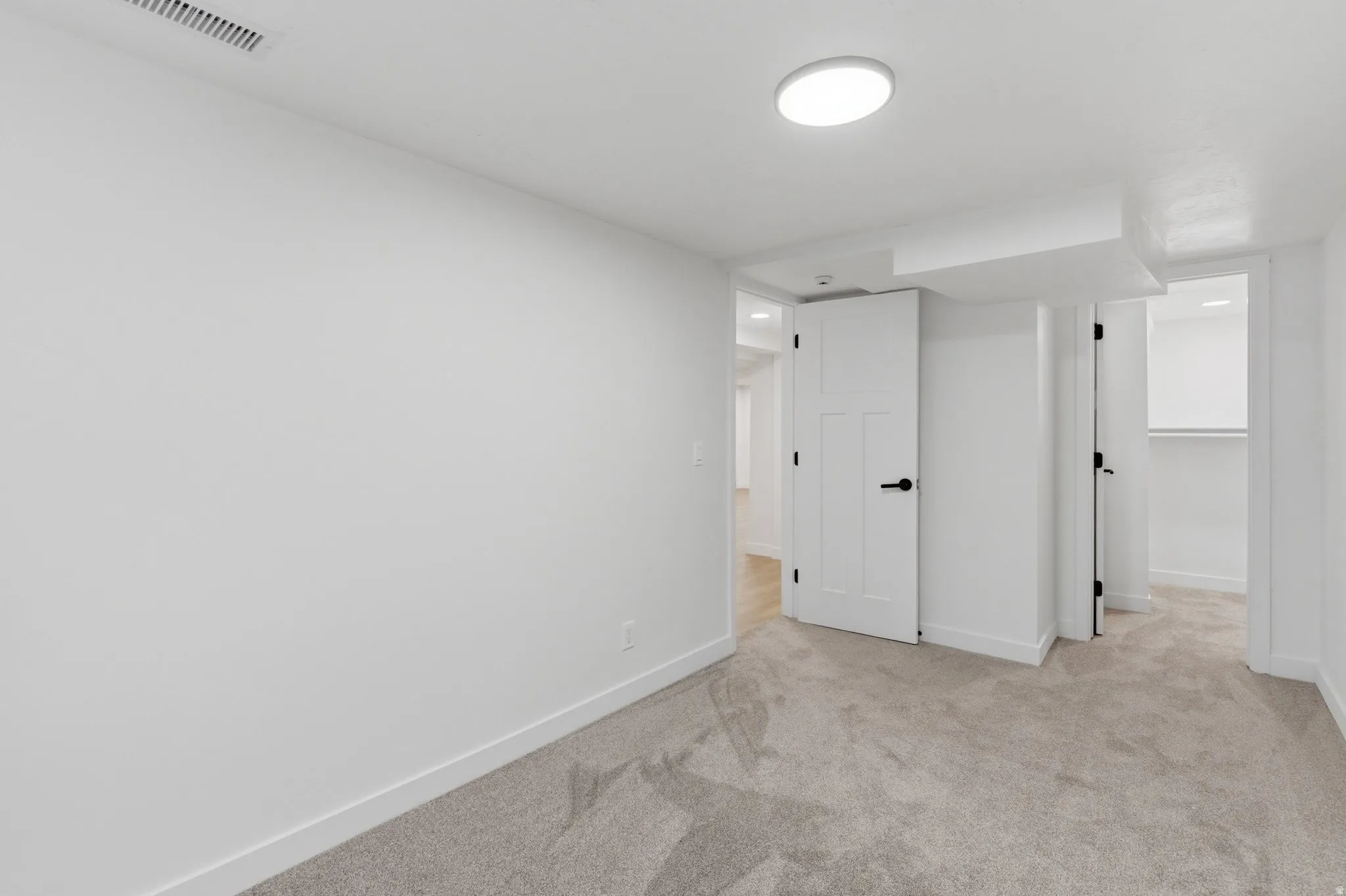 Neutral-toned carpeting and white walls