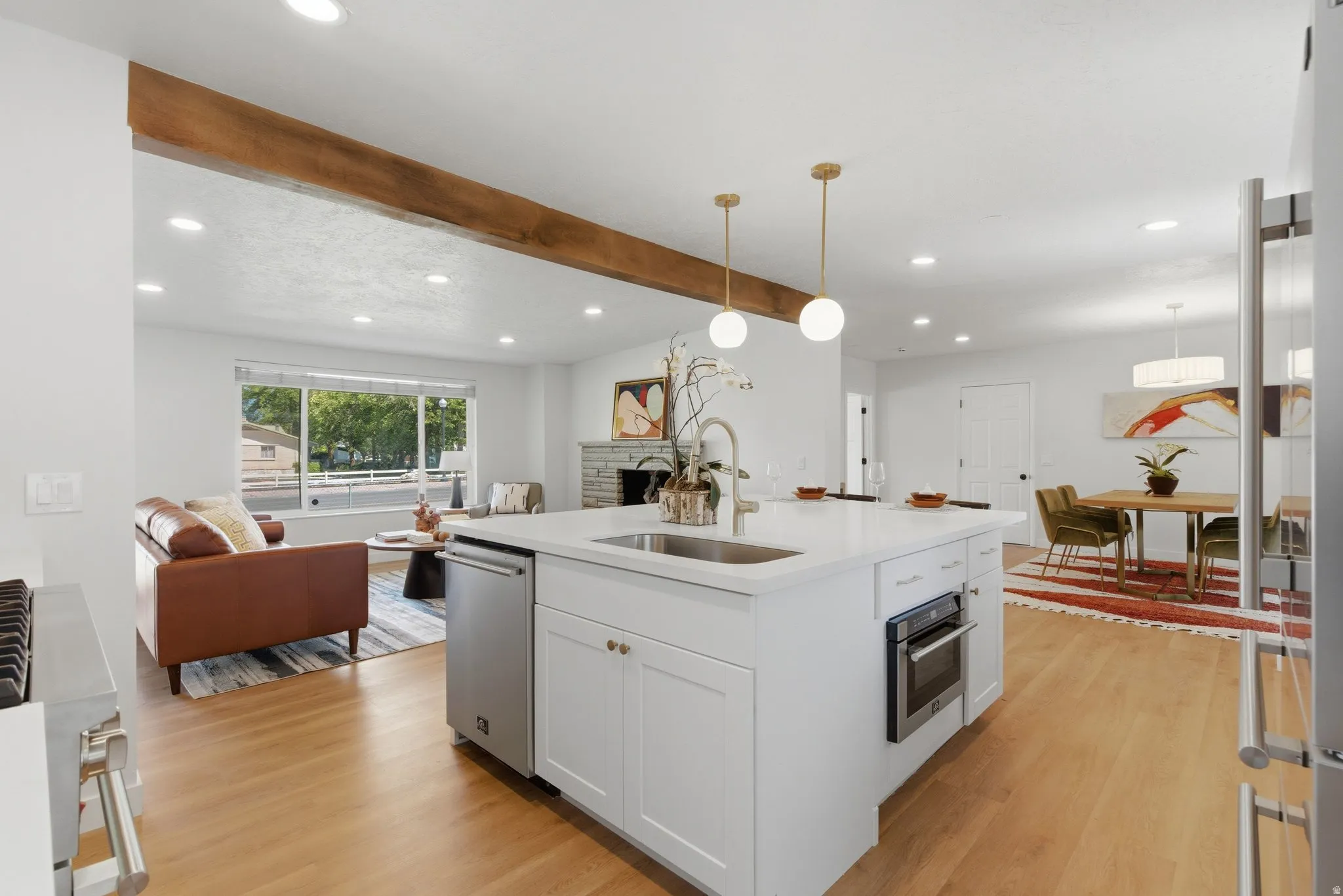 Kitchen island with an undermount stainless steel sink, gold-toned faucet, and integrated dishwasher