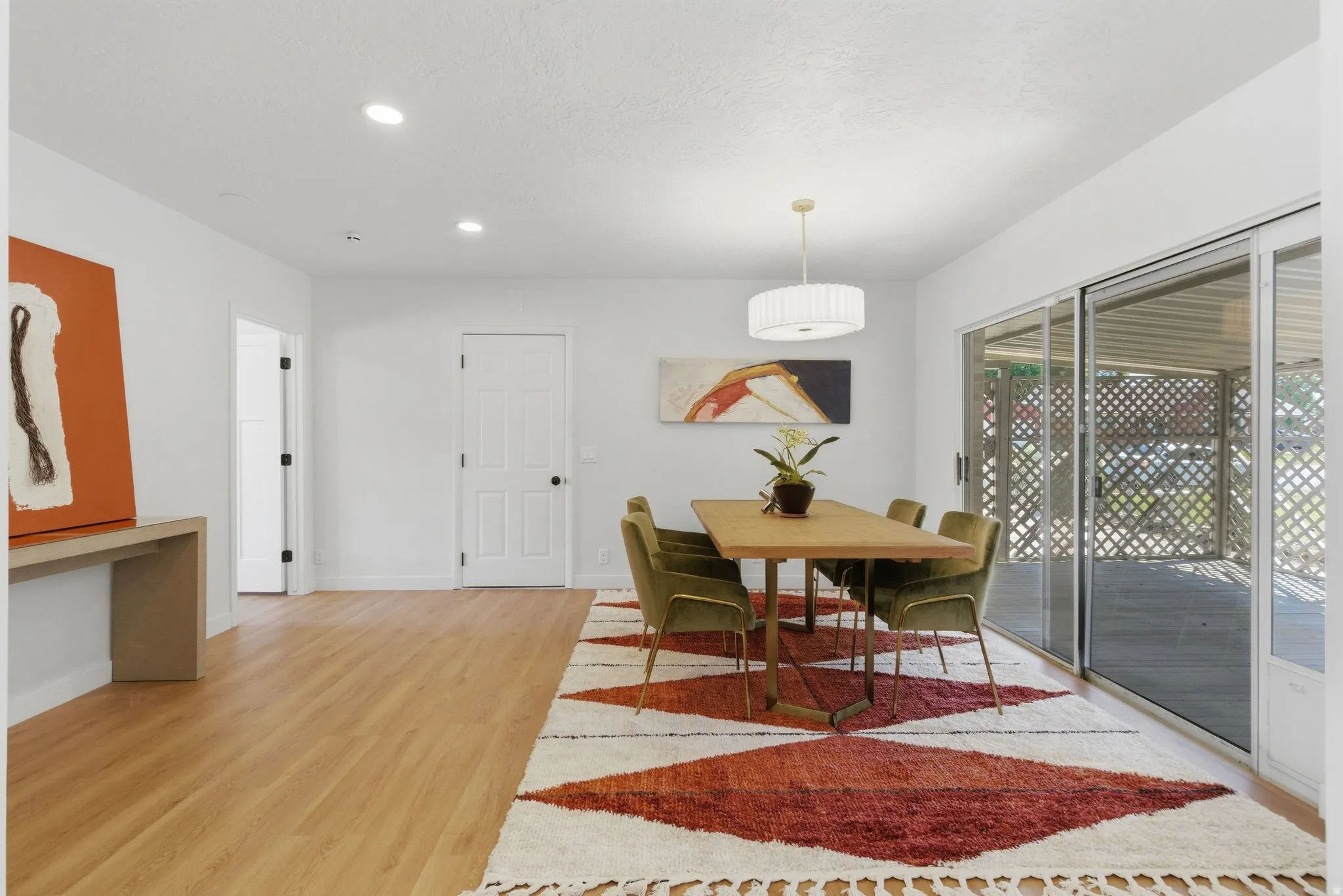Bright dining area with wood-finish flooring and recessed lighting