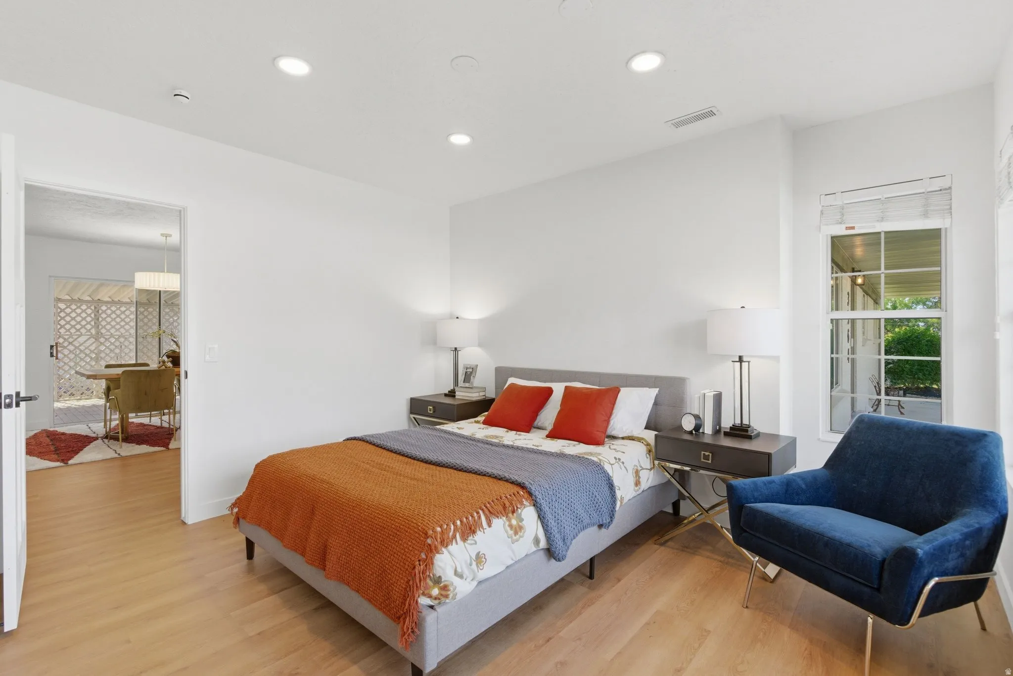 Light wood-finish flooring extending through an open doorway