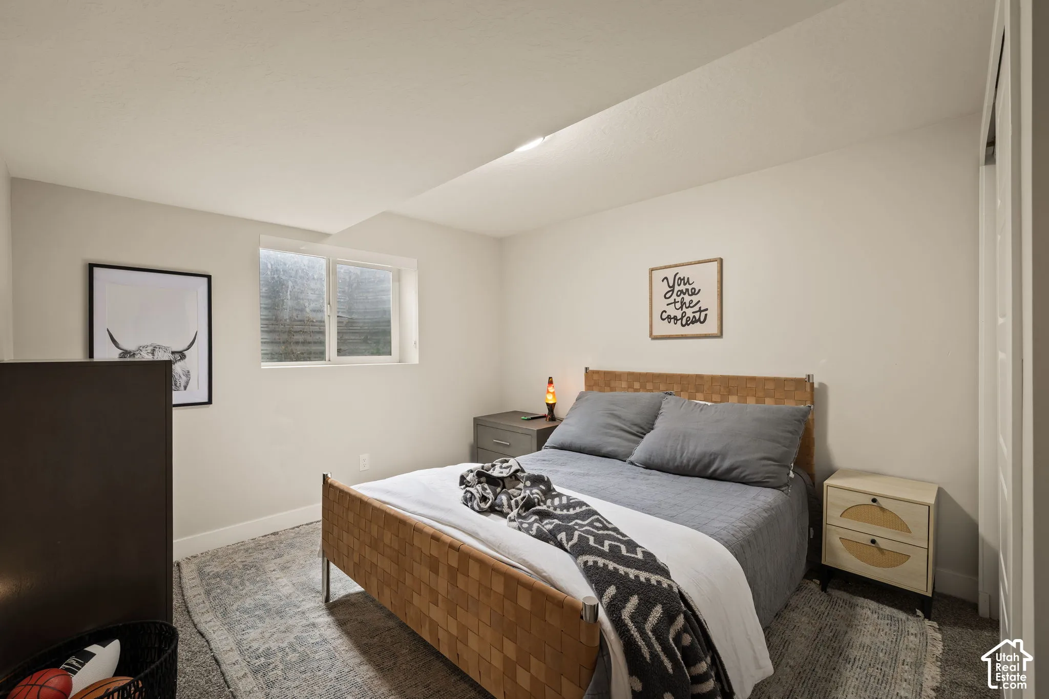 Bedroom featuring a window, light gray walls, white trim, and a patterned area rug