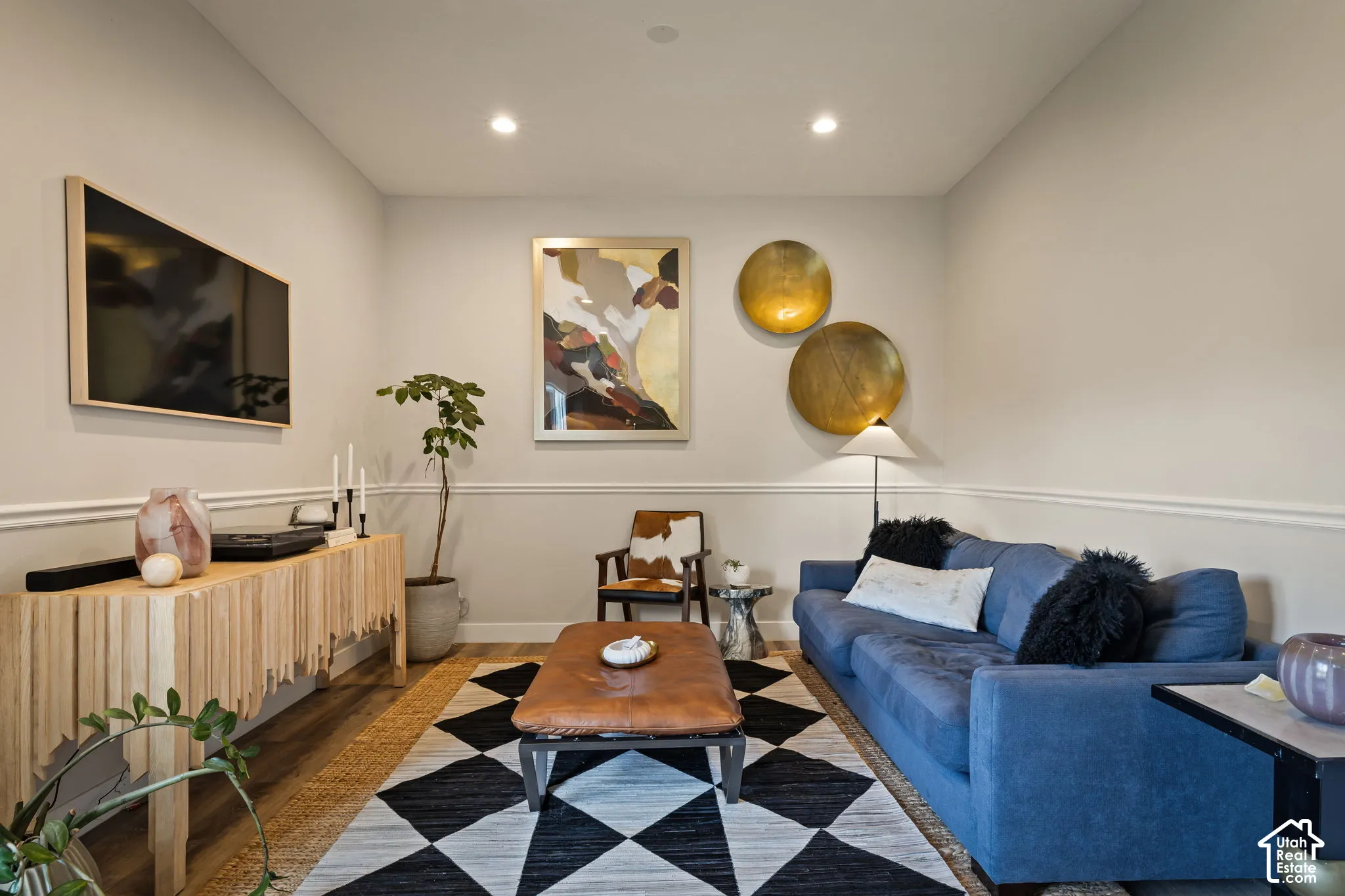 Living area featuring recessed lighting, chair rail molding, and wood-finish flooring