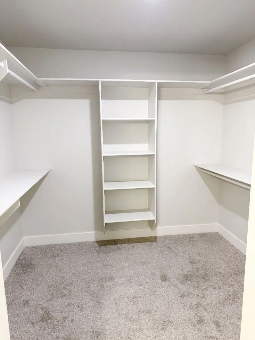 White custom closet system with shelving and hanging rods