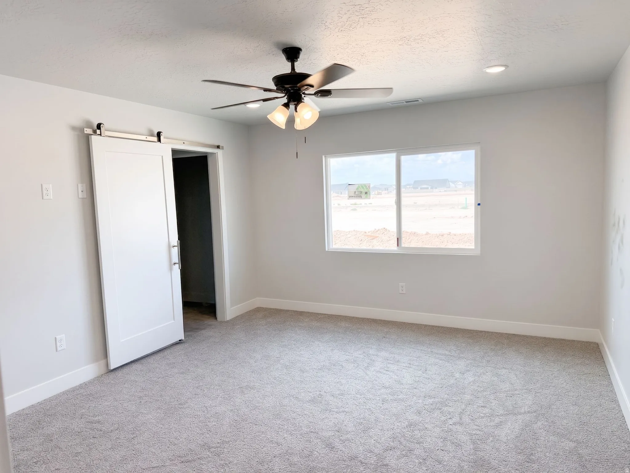 Neutral-toned carpeting, white walls, and recessed lighting