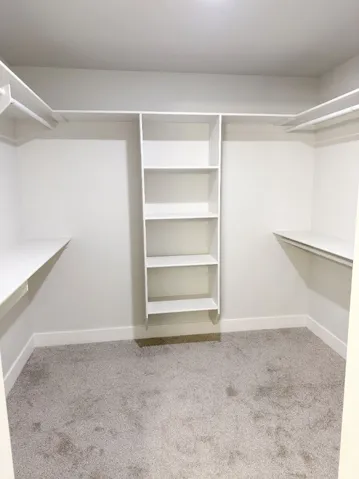 White custom closet system with shelving and hanging rods