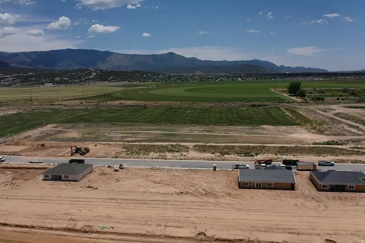 Expansive rural landscape featuring distant mountains and cultivated fields