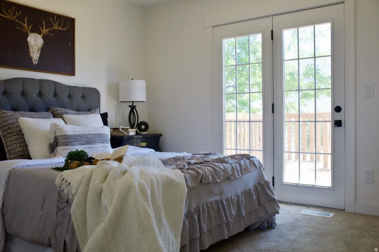 White French doors with grid-patterned glass panels open to a wooden deck