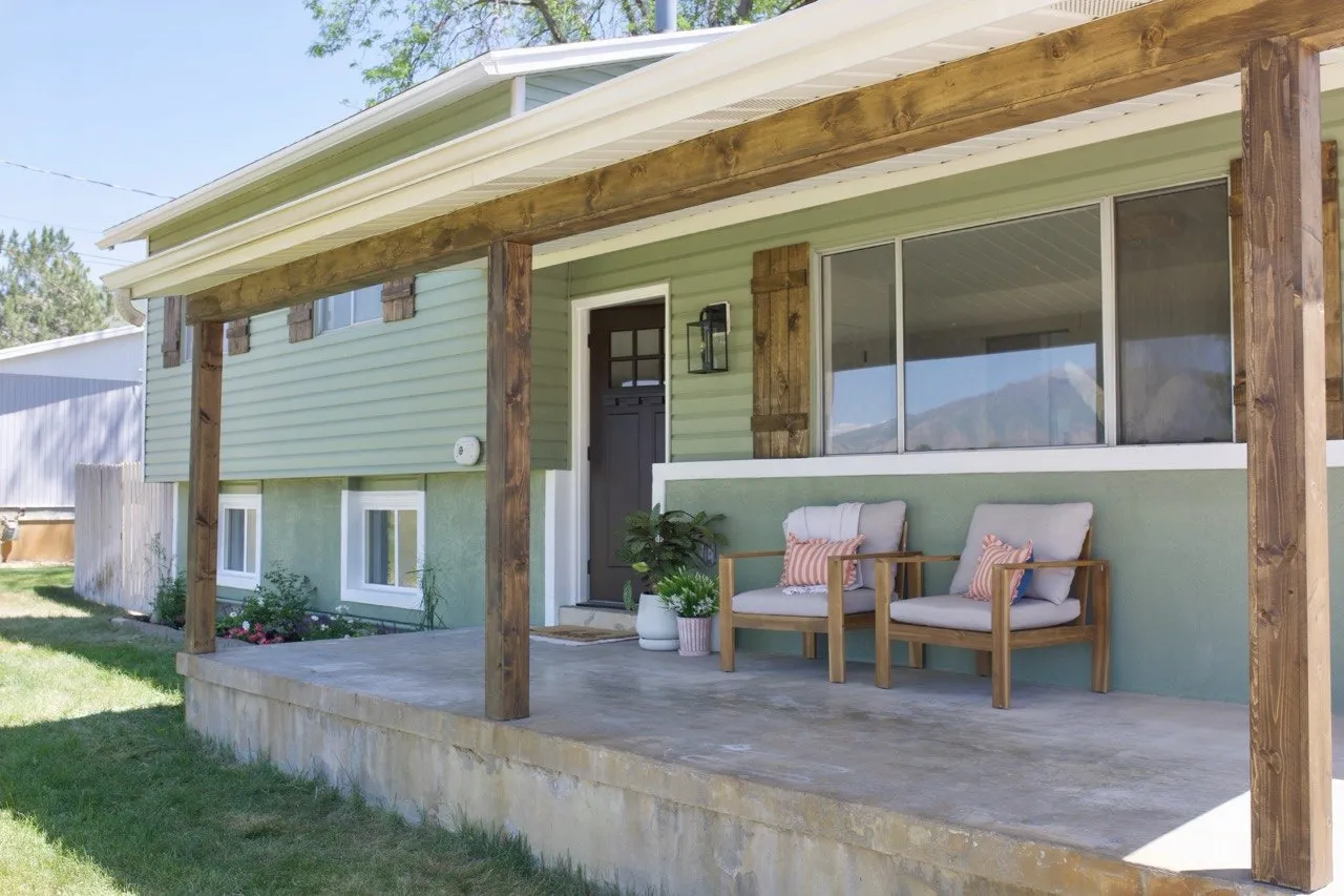 Front porch with wood-finish support beams and a concrete surface