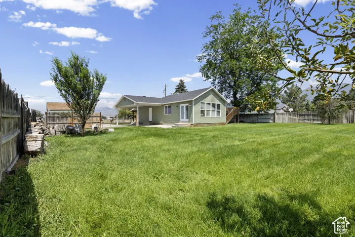 Expansive grassy yard with mature trees