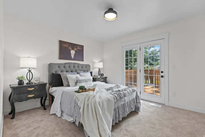 White walls, carpeted flooring, and a flush-mount ceiling light