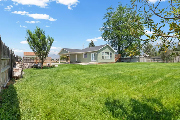 Expansive grassy yard with mature trees