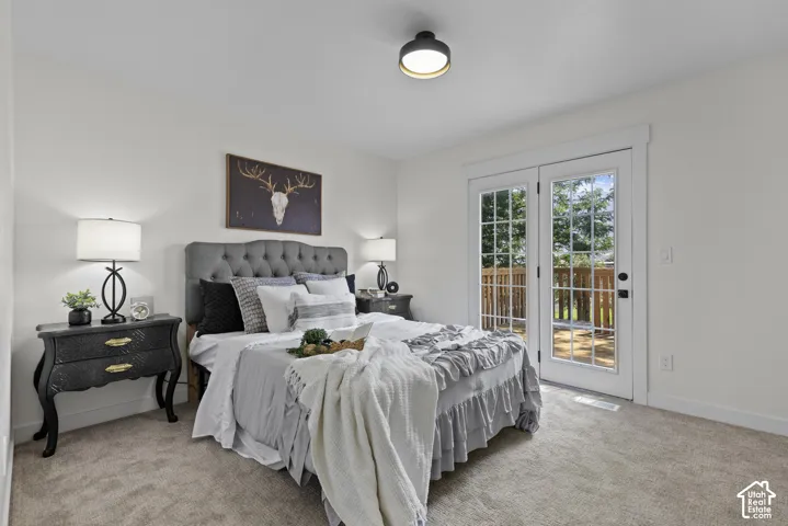 White walls, carpeted flooring, and a flush-mount ceiling light
