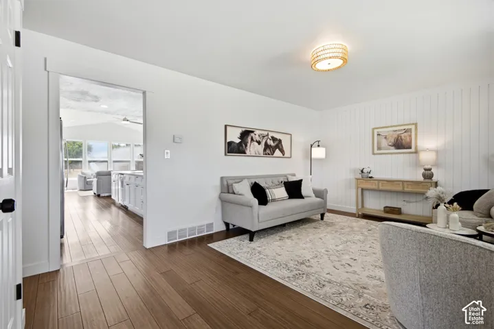 Wood-finish flooring throughout, bright white walls, and a recessed ceiling light fixture