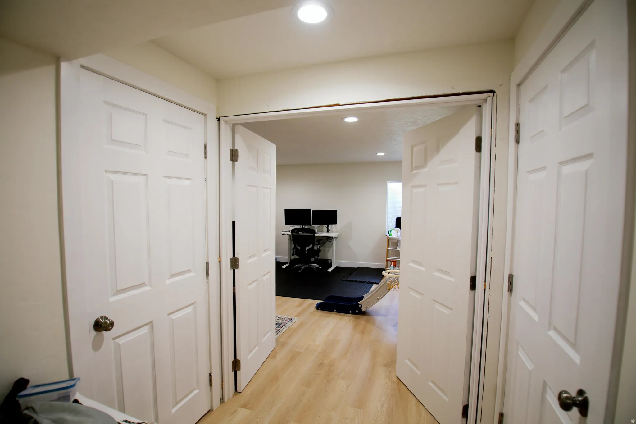 Interior entryway featuring light wood-finish flooring, white walls, and a recessed ceiling light