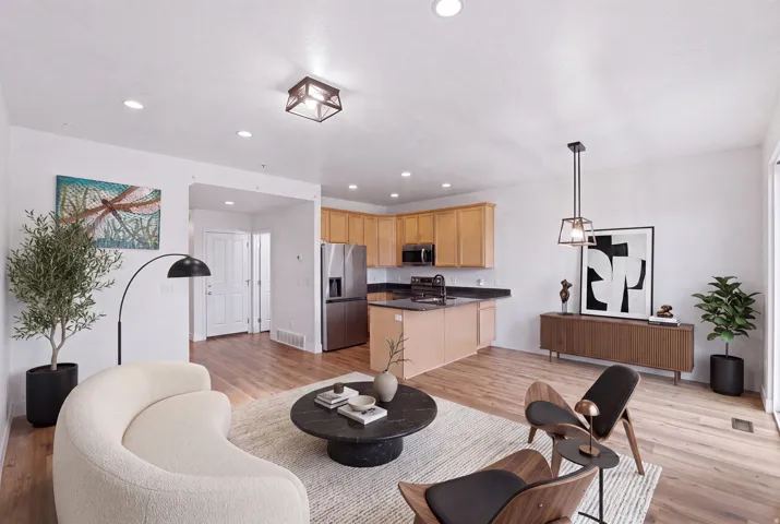 Open-concept living space with wood-finish flooring