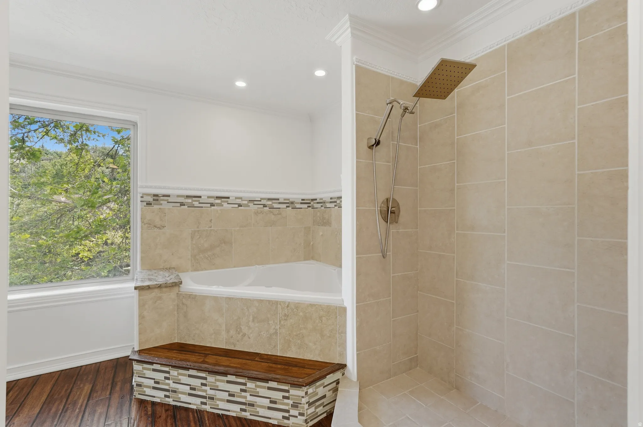 Shower stall with light-toned rectangular wall tile and a rain shower head