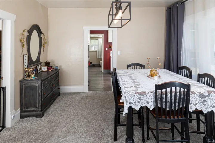 Spacious room featuring neutral wall tones and plush gray carpeting
