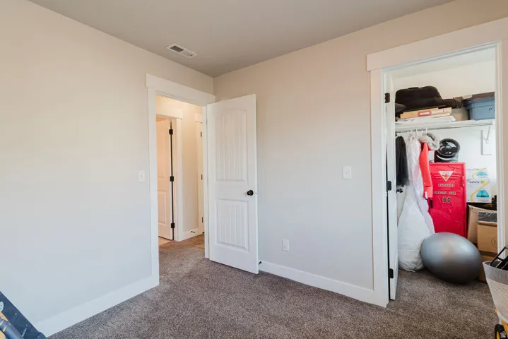 Neutral-toned walls and plush gray carpeting