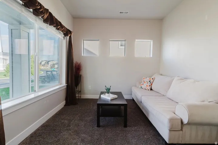 Broad window offering exterior views, complemented by three square wall recesses