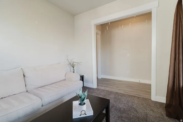 Neutral wall paint in a living area featuring carpet flooring