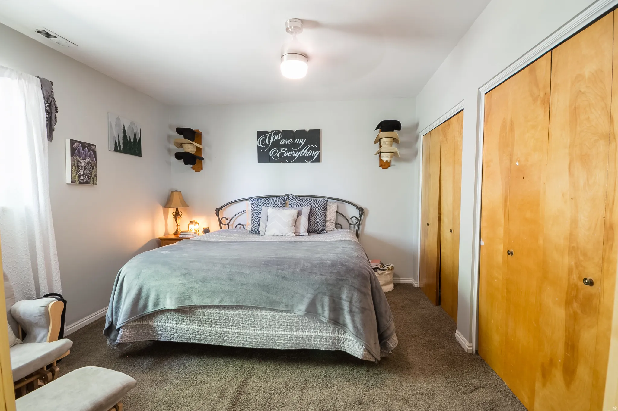 Carpeted room featuring a ceiling-mounted light fixture and light-toned walls