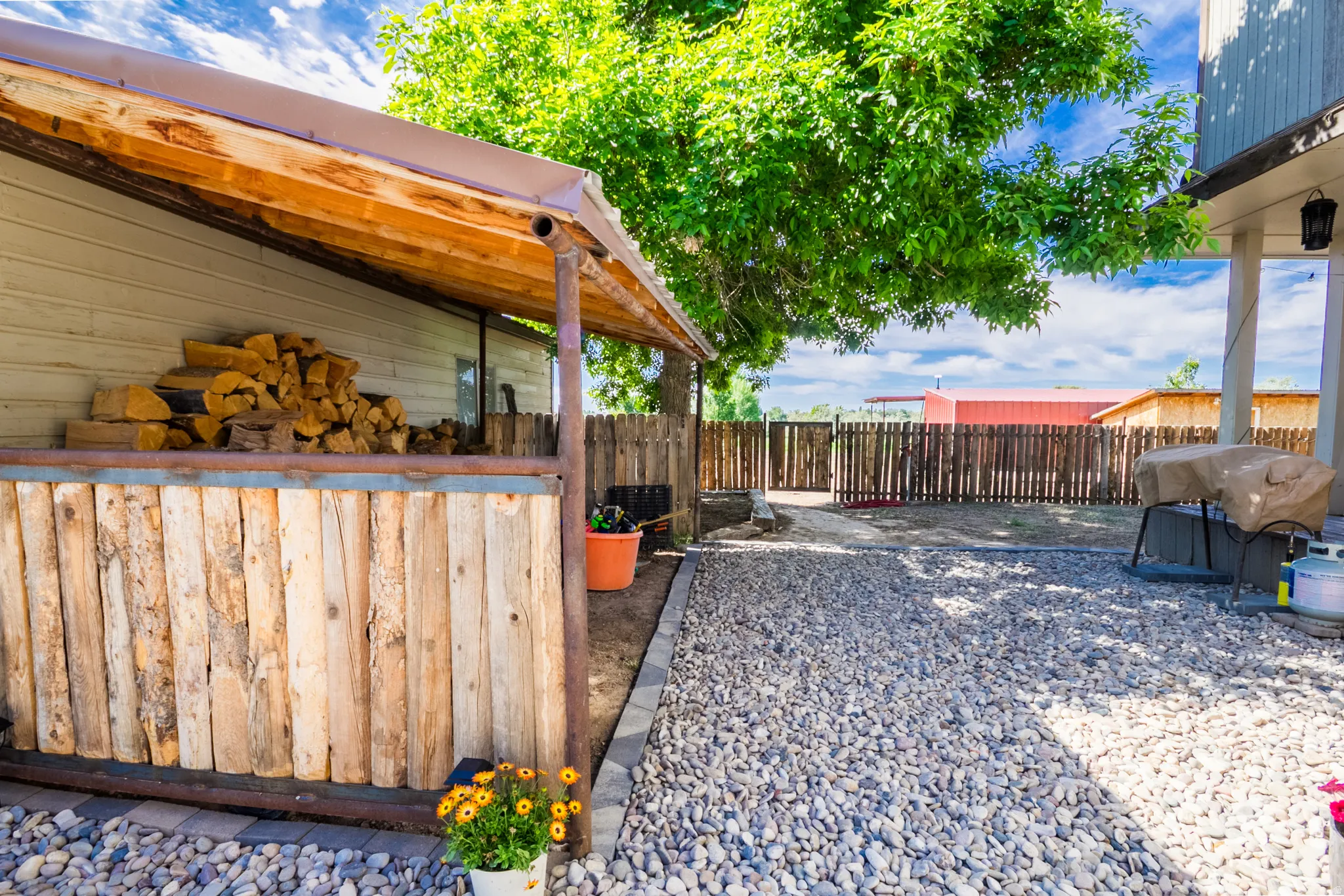 Outdoor covered storage structure with a wood-plank facade