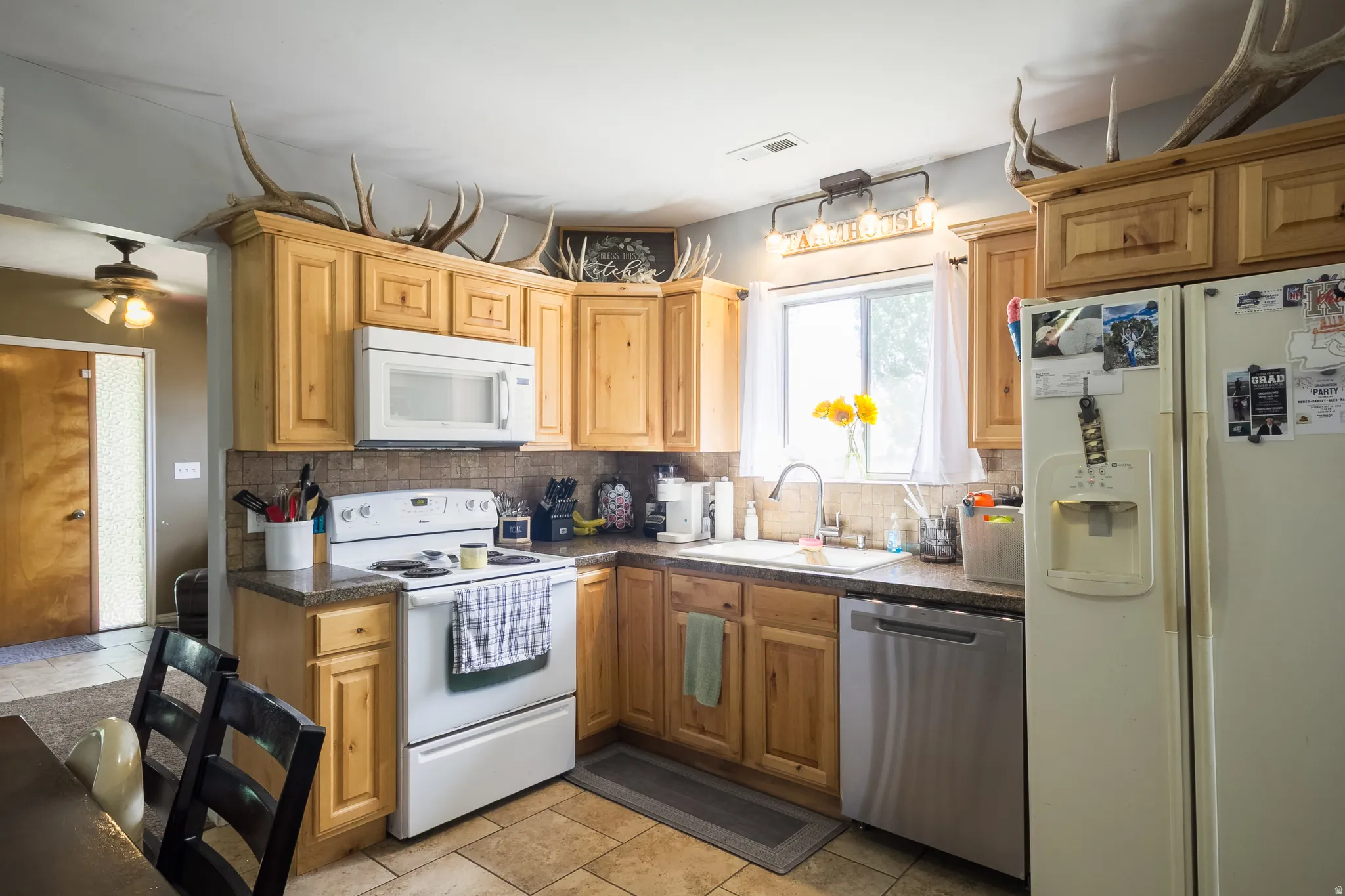Kitchen featuring wood cabinetry, stone-look countertops, and tile flooring
