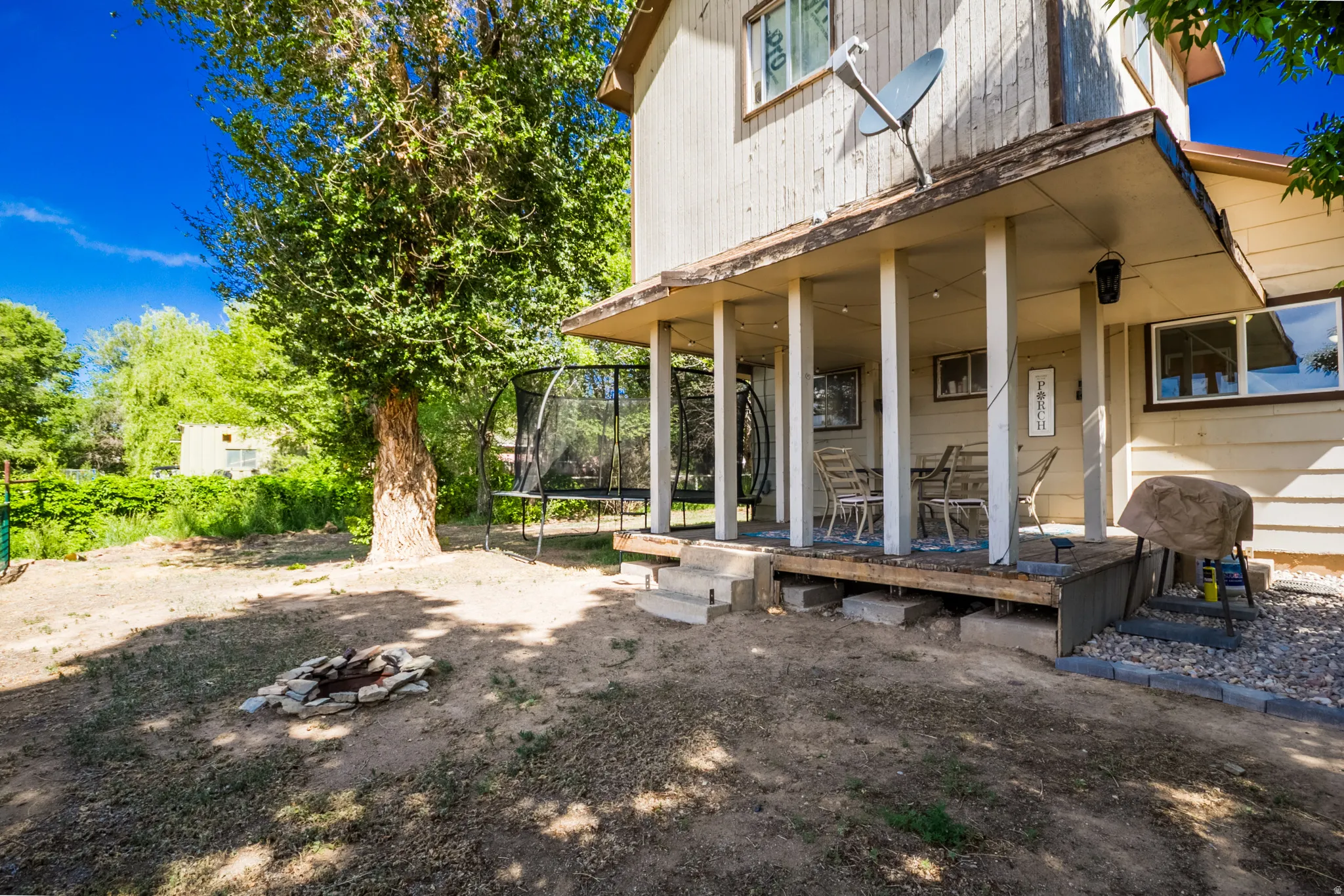Covered outdoor patio with a wooden deck