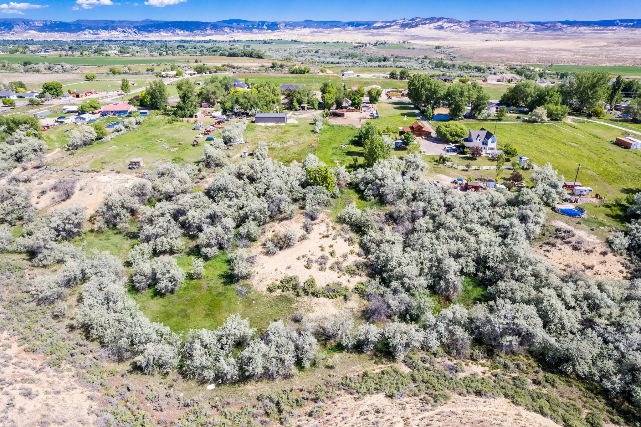 Expansive land featuring natural shrubbery and open green spaces