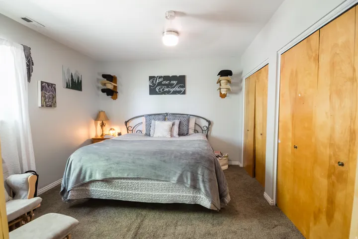 Carpeted room featuring a ceiling-mounted light fixture and light-toned walls