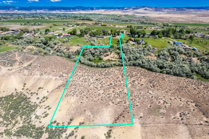 Expansive land parcel featuring natural shrubbery and varied topography, outlined by a clear boundary