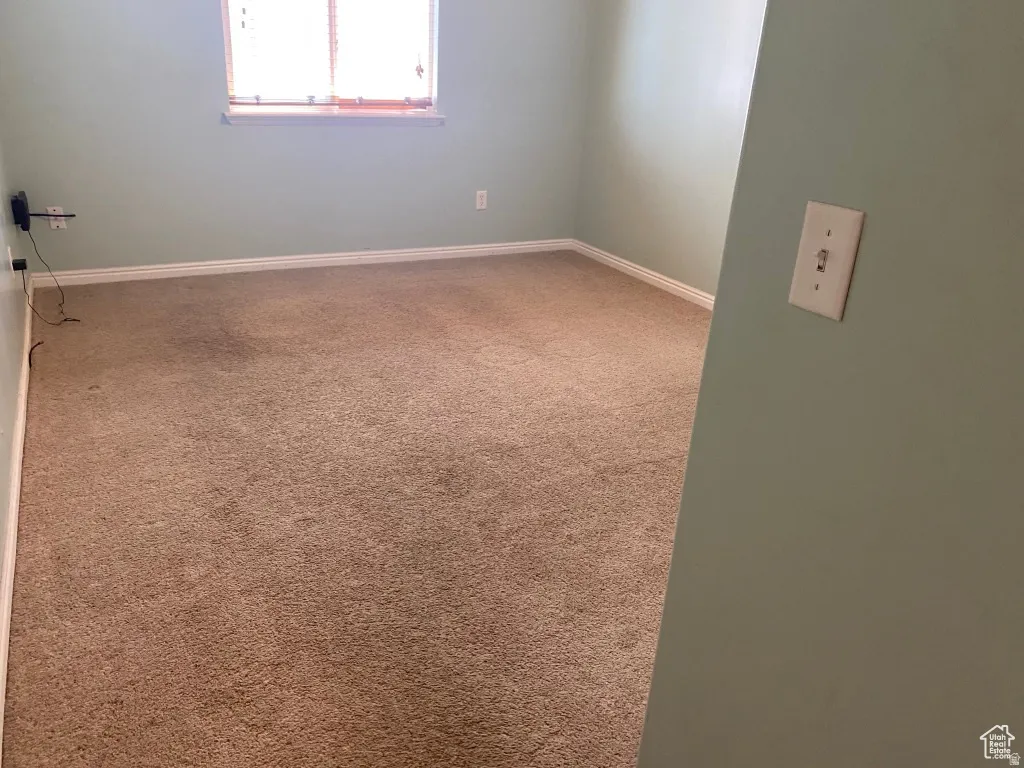 Bedroom 3: Carpeted interior space with light-colored walls and white baseboards