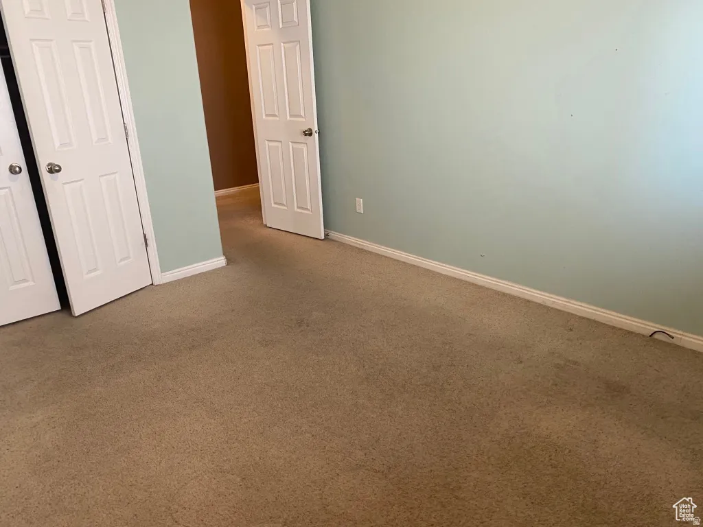 Bedroom 3: Carpeted room featuring a light green wall color and white baseboards