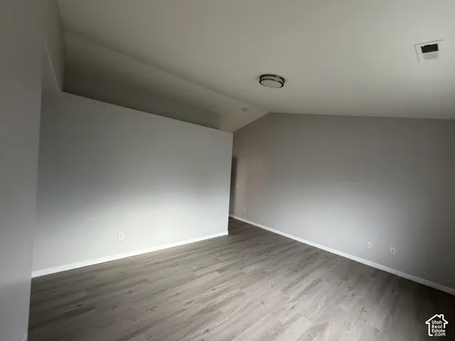 Primary bedroom with LVP flooring with serene wall tones and white trim