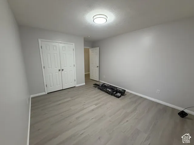 Bedroom 3 Light gray walls, LVP flooring, white trim, and a flush mount ceiling light