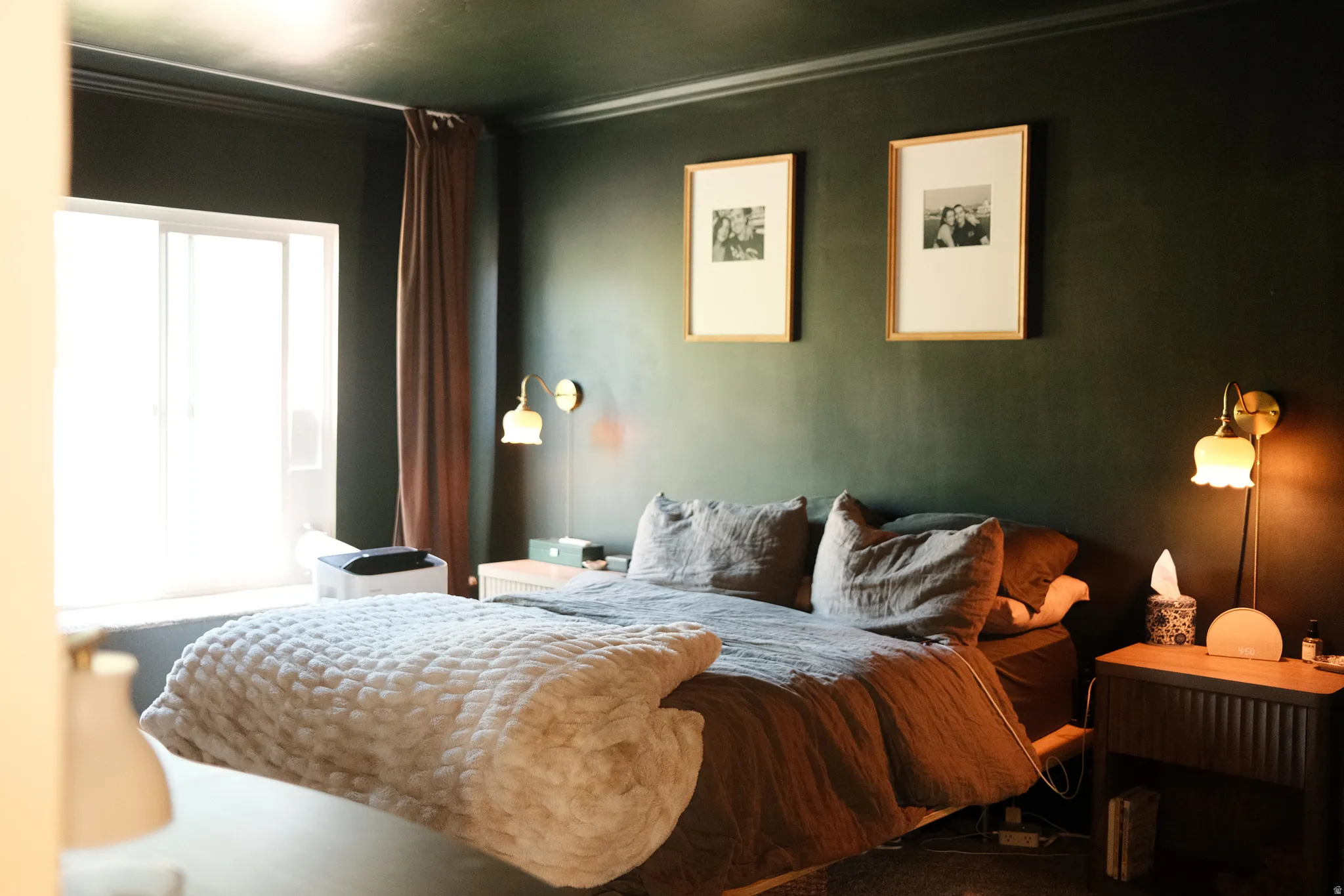 Dark-toned walls featuring crown molding and a large sliding window with a window ledge
