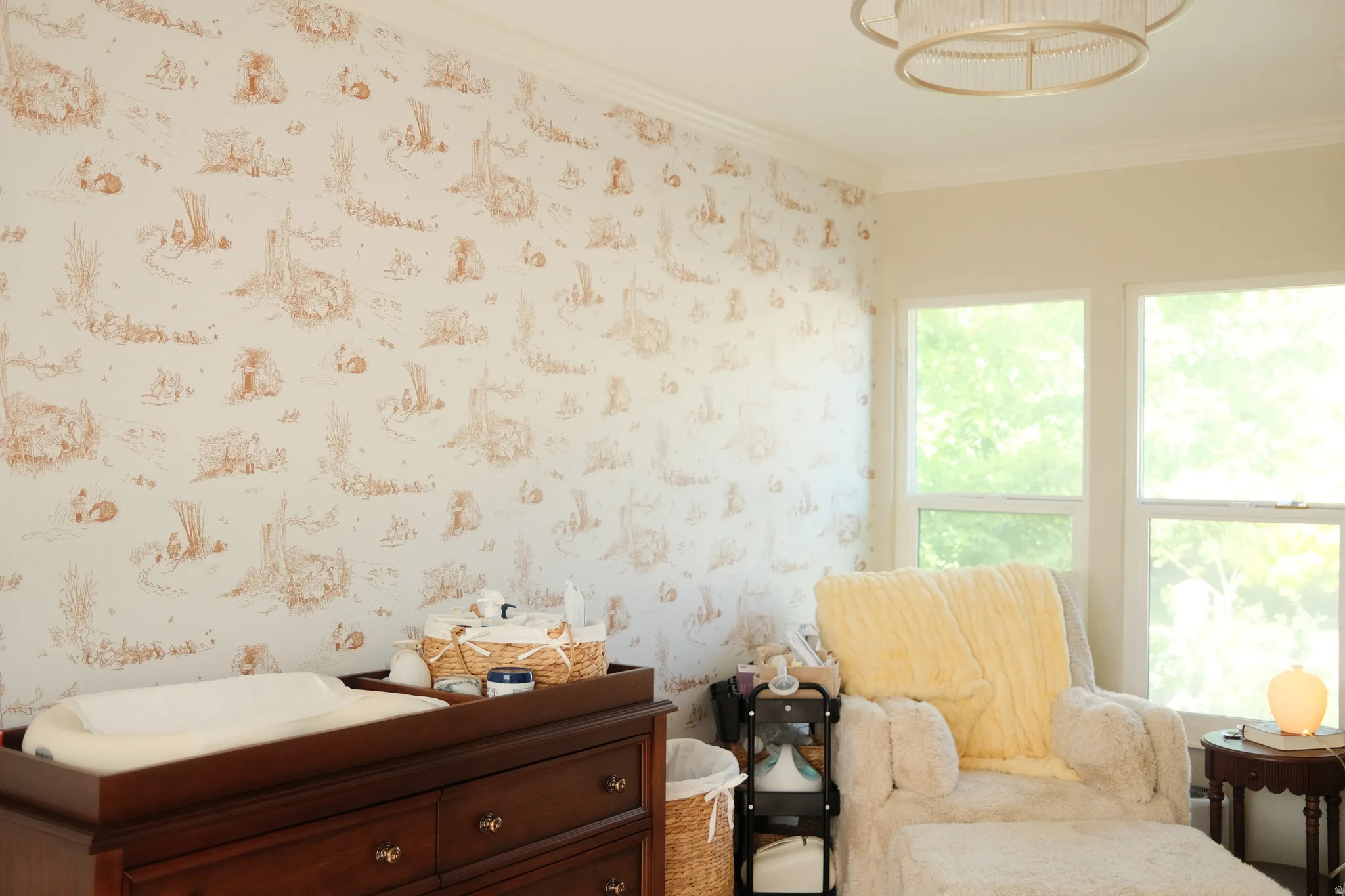 Room featuring decorative wallpaper, crown molding, and a multi-pane window assembly