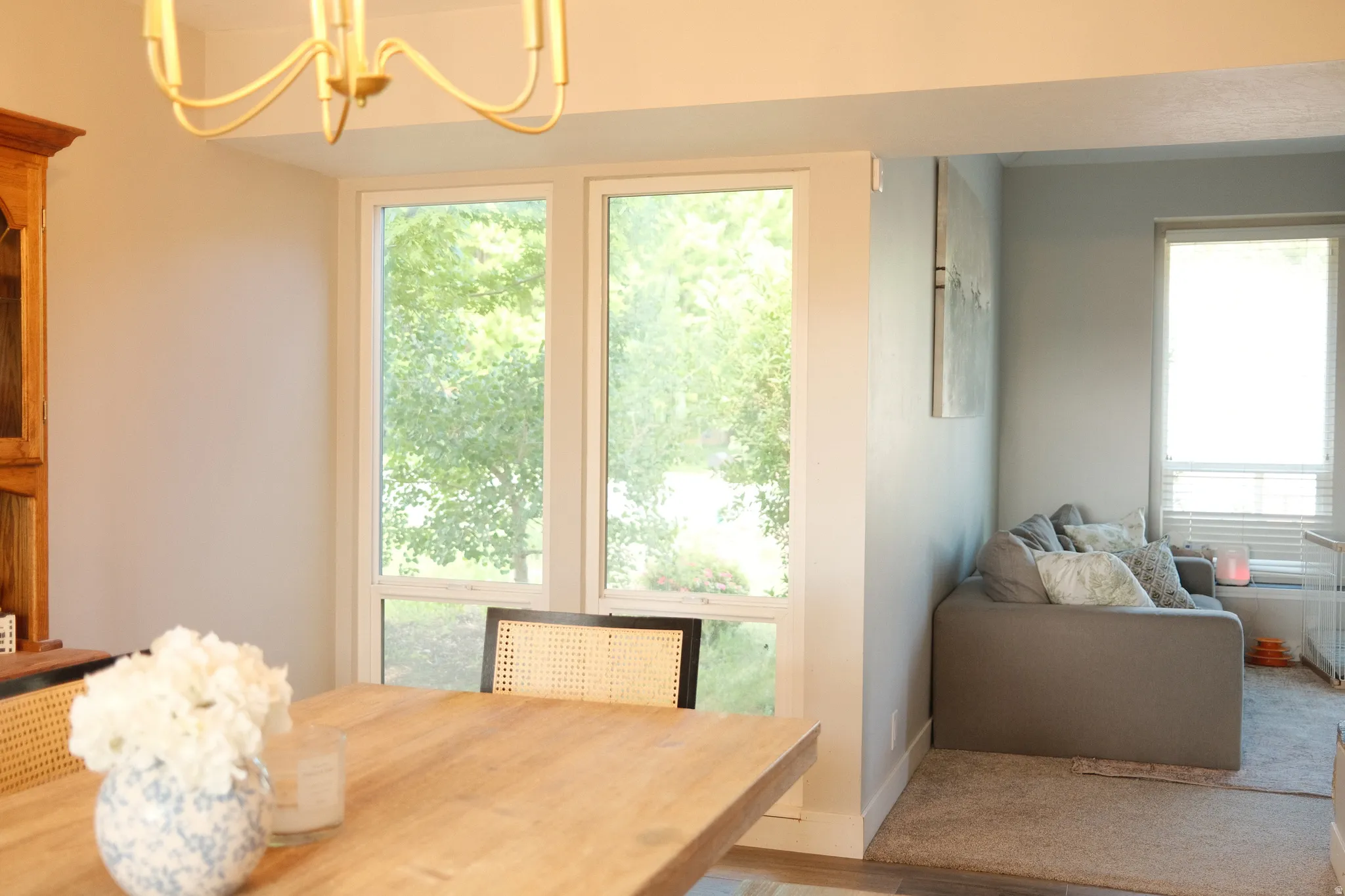 Dining area featuring recessed lighting, a chandelier, and a large window overlooking exterior greenery