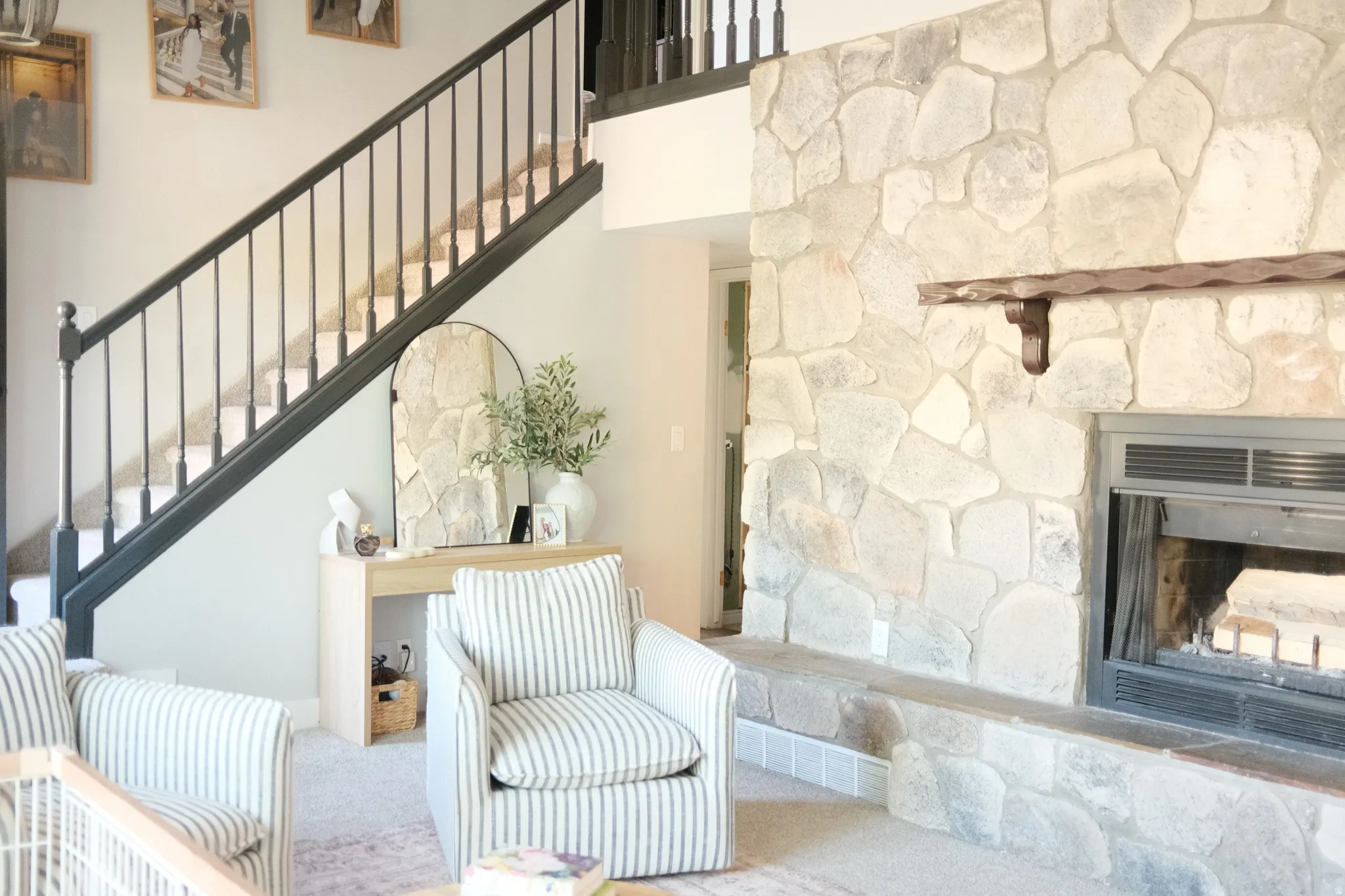 Stone fireplace with a substantial wood mantel