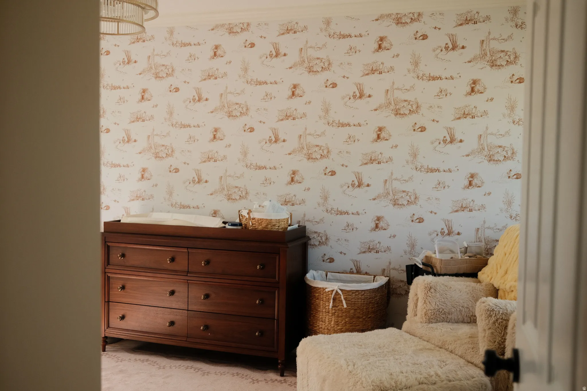 Wallpapered room featuring a decorative overhead light fixture