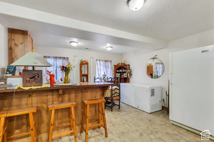 Wood-paneled bar with countertop, all under ceiling-mounted light fixtures