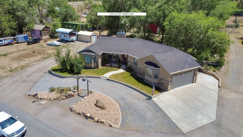 Ranch-style residence featuring a stone and stucco exterior, an attached two-car garage, and a concrete driveway