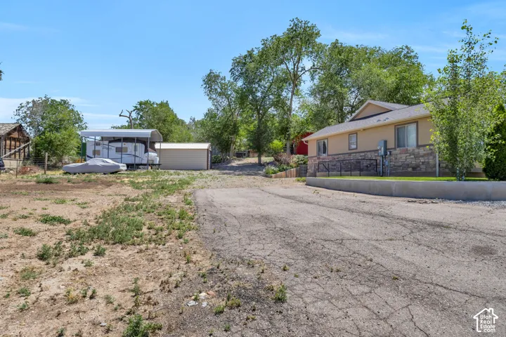 side yard with garden area on the left leading into the barnyard beyond