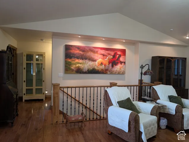Hardwood-finish flooring extending into a hallway with a display cabinet