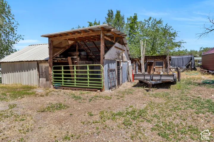 Agricultural outbuilding featuring a metal roof and open-air structure