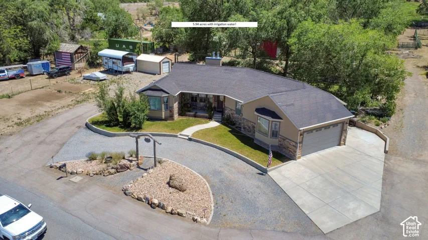Ranch-style residence featuring a stone and stucco exterior, an attached two-car garage, and a concrete driveway