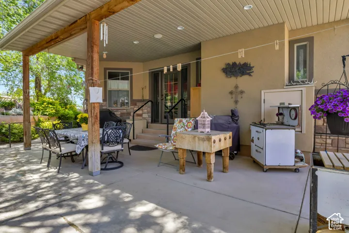Expansive covered patio featuring a concrete surface and wood support beams