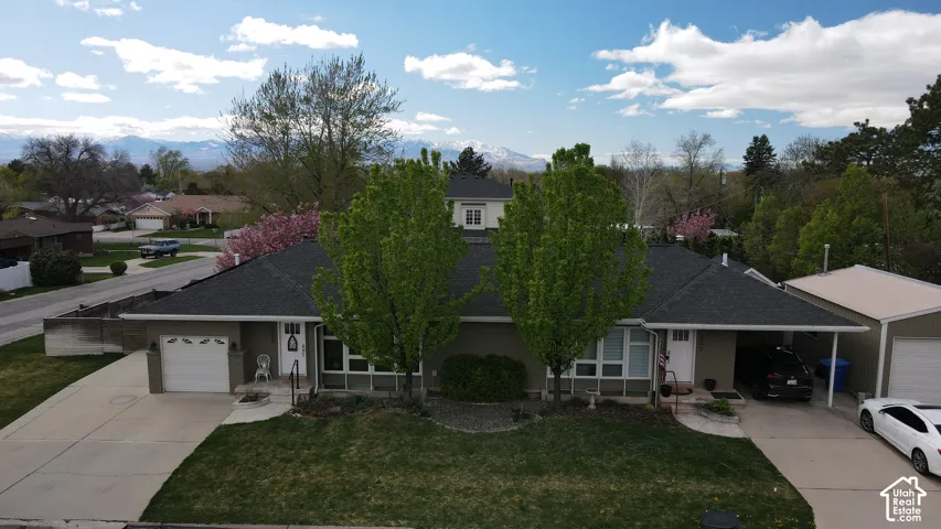 Duplex property featuring a split-level design with two distinct entrances and separate garages