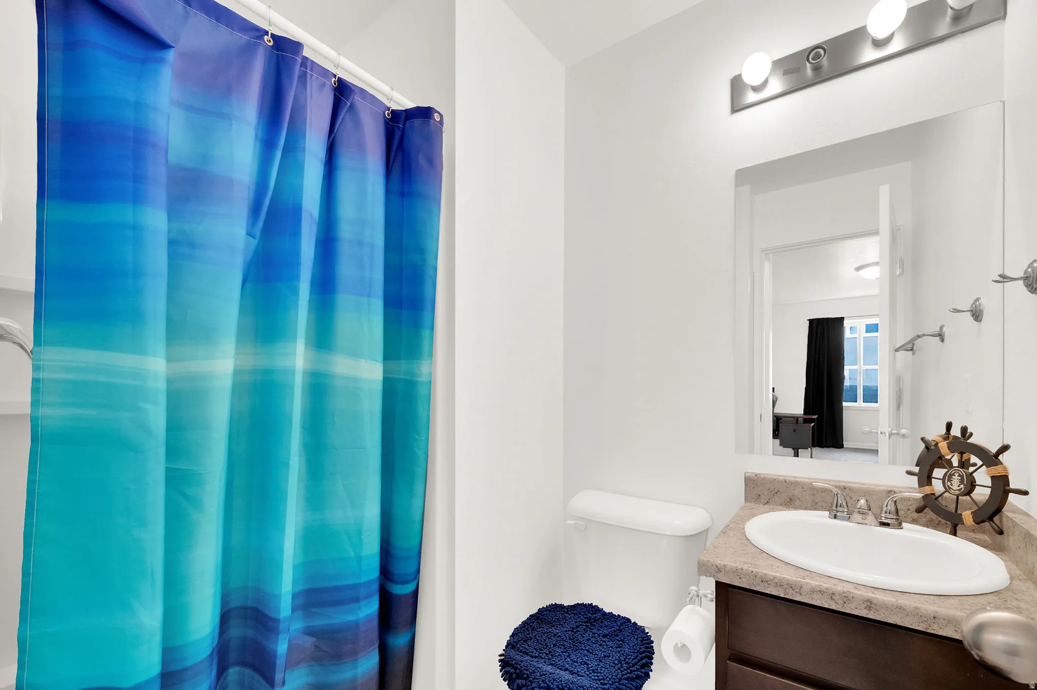 Full bathroom featuring a single-sink vanity with a countertop, a toilet, and a shower/tub combination