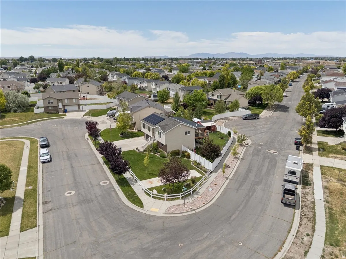Corner lot residence featuring a two-story design, a two-car garage, and solar panels